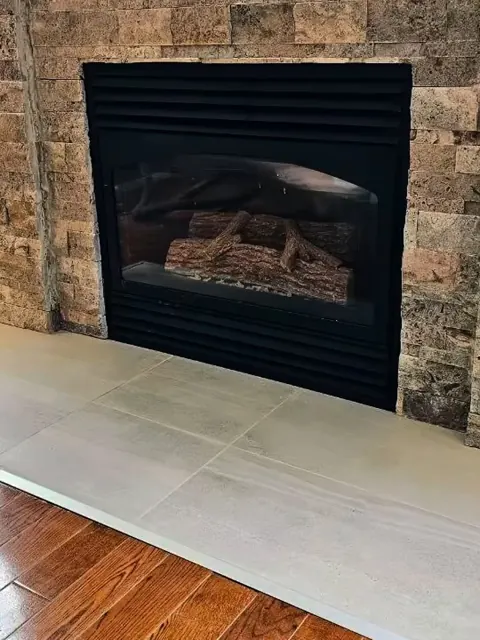 After: stacked stone around the firebox and a large tile hearth